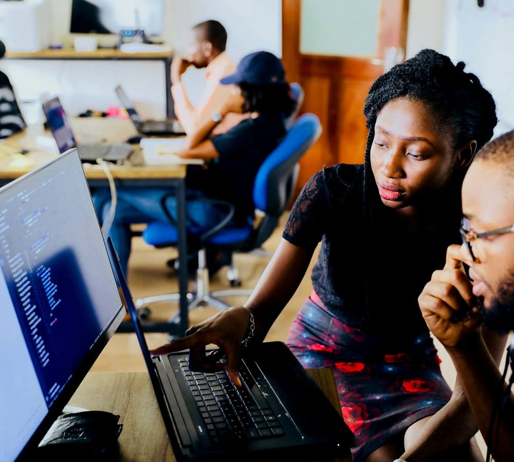 Two learners working through a lesson on a laptop
